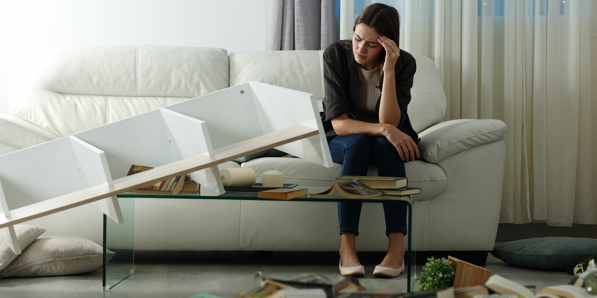 Woman visibly upset by property damage in her living room