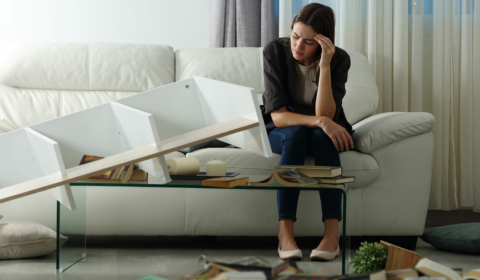 Woman visibly upset by property damage in her living room