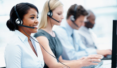 Workers in a contact center responding to incoming phone calls.