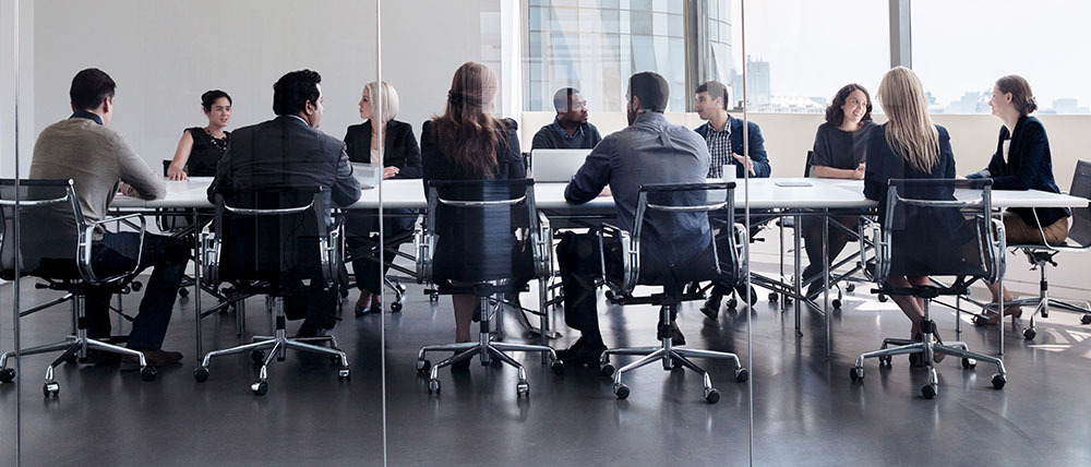 Executives gathered around a conference room table