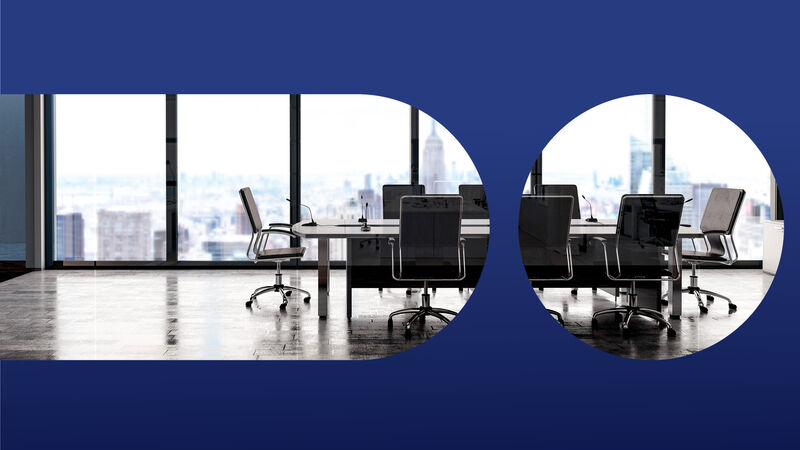 An empty office conference table in a high rise building overlooking New York City