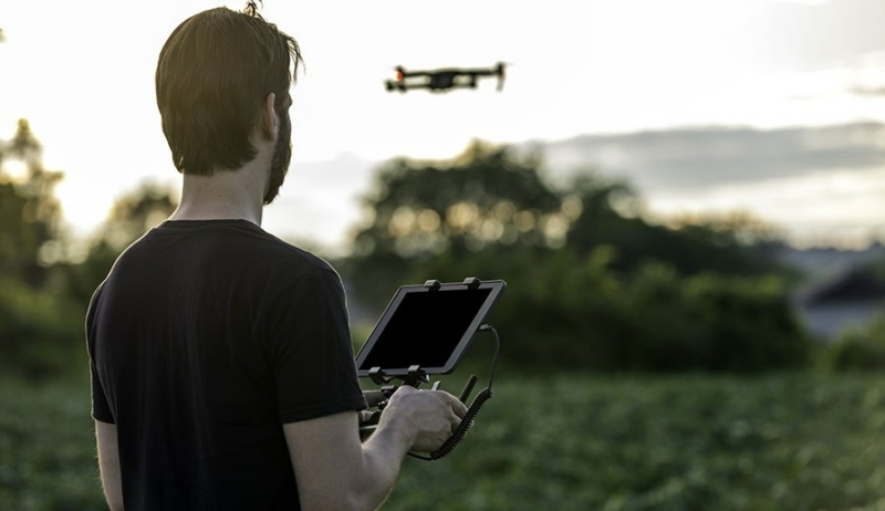 Drone pilot operating a drone outdoors