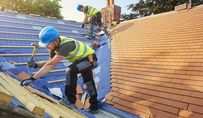 Roofing contractors installing a roof