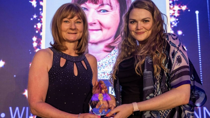 Sarah Baker receiving her trophy at the Women in Insurance Awards 2021