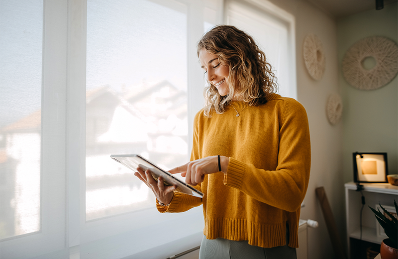 Woman using ipad in her home