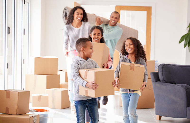 Family moving boxes in home